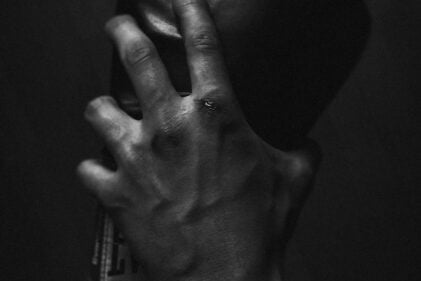 Grayscale Photo of Person Holding Boxing Glove